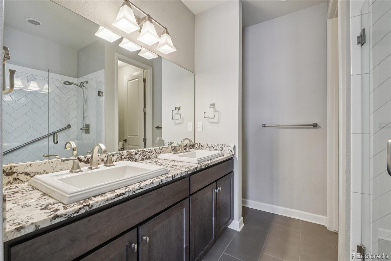 6523 Independence Street Frederick, CO 80516 - Photo 11 of 21 a bathroom with a sink double vanity and a mirror