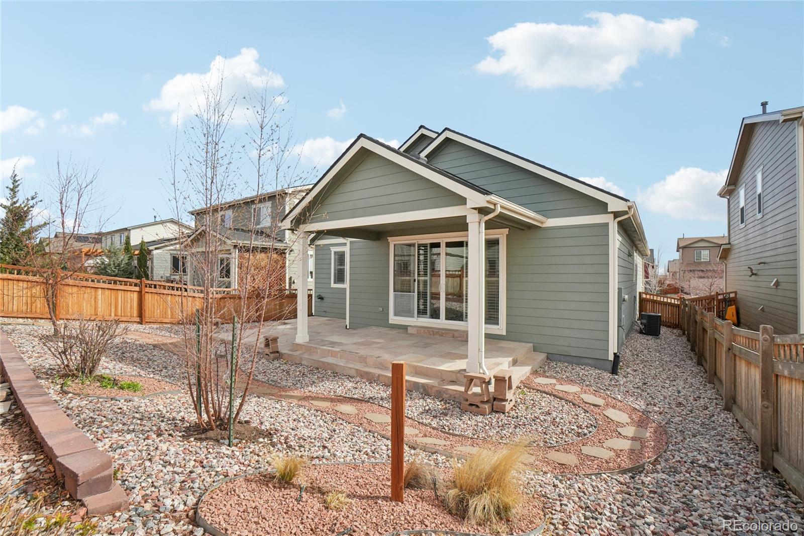 6523 Independence Street Frederick, CO 80516 - Photo 15 of 21 a front view of a house with garden