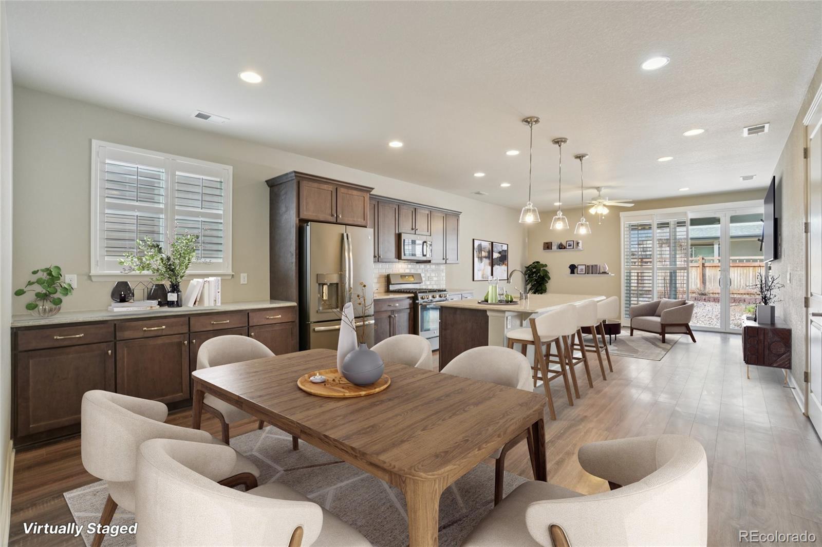6523 Independence Street Frederick, CO 80516 - Photo 2 of 21 a view of a dining room with furniture and wooden floor