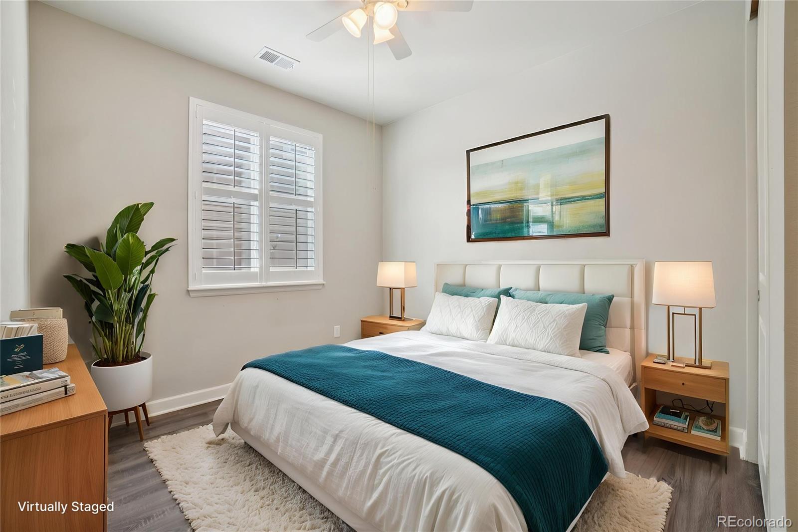 6523 Independence Street Frederick, CO 80516 - Photo 4 of 21 a bedroom with bed and a potted plant