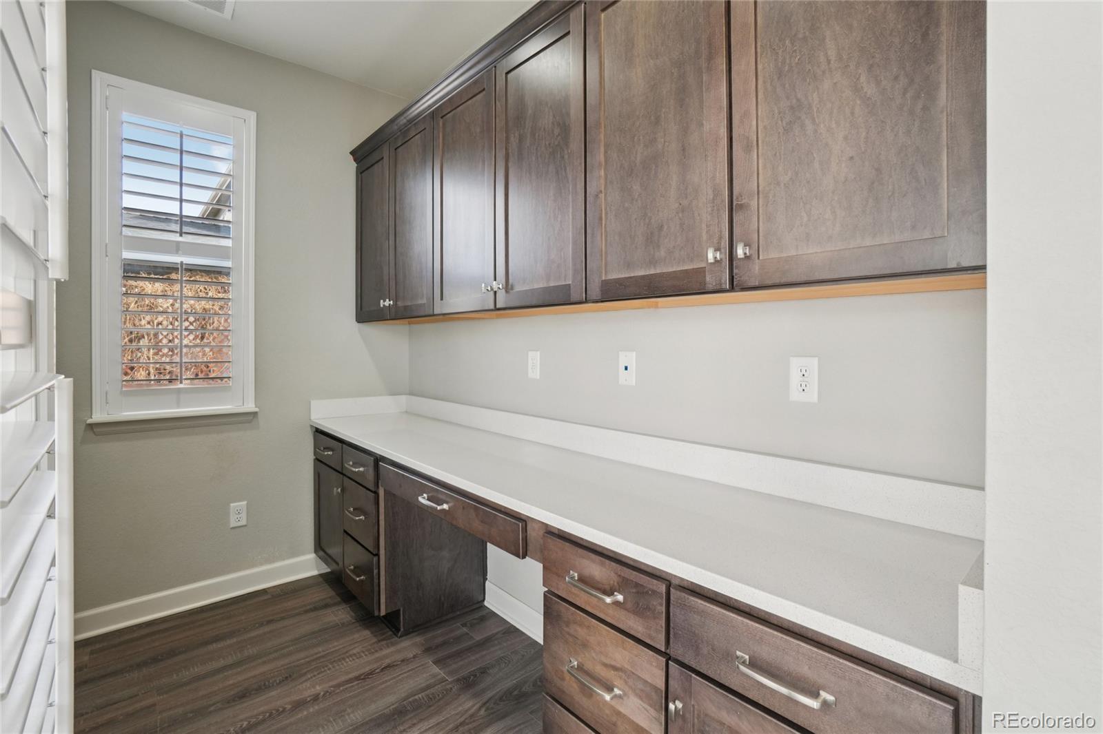 6523 Independence Street Frederick, CO 80516 - Photo 9 of 21 a view of cabinets with wooden floor and cabinets
