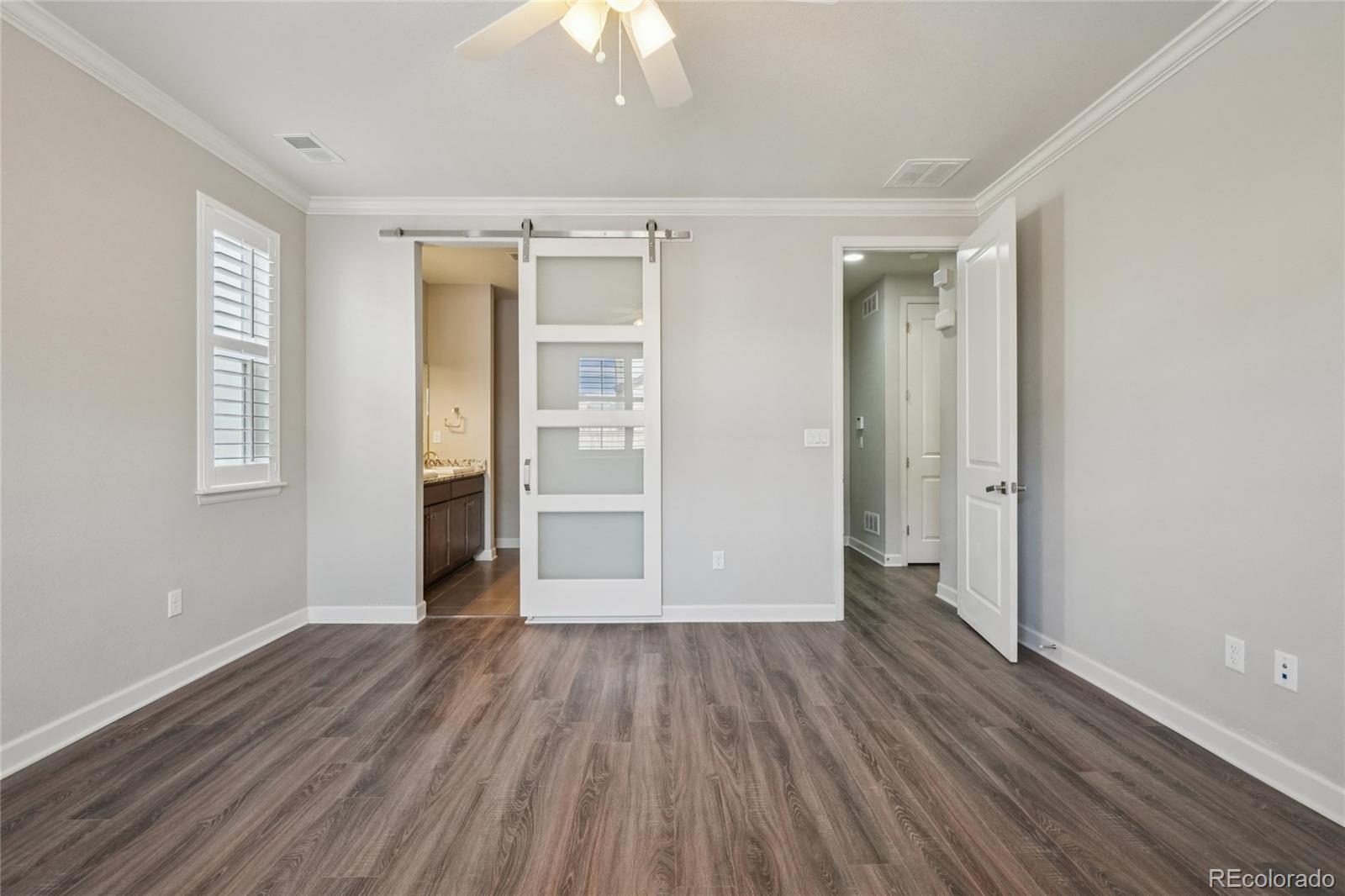 6523 Independence Street Frederick, CO 80516 - Photo 10 of 21 wooden floor in an empty room with a window