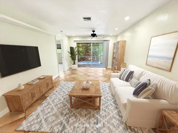 a living room with furniture window and a flat screen tv