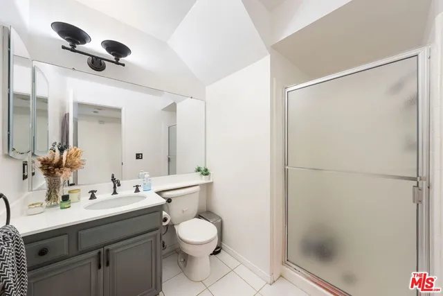 a bathroom with a toilet a sink and a mirror