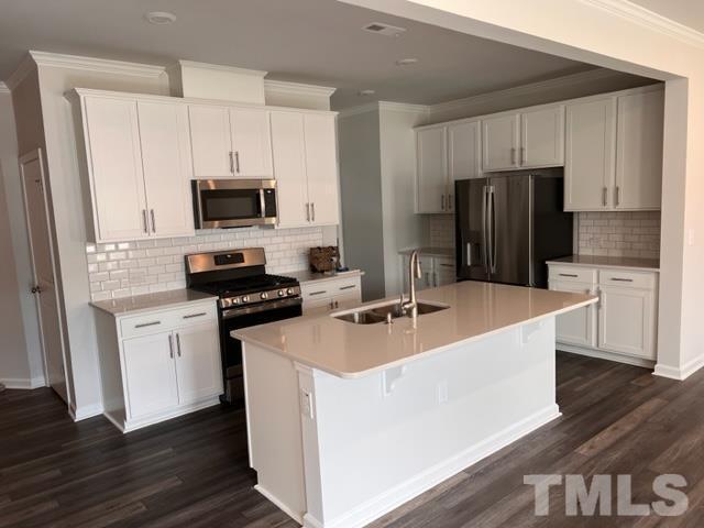 2403 Chert Lane, Unit 2403 Raleigh, NC 27610 - Photo 3 of 19 a kitchen with stainless steel appliances a refrigerator stove microwave and sink