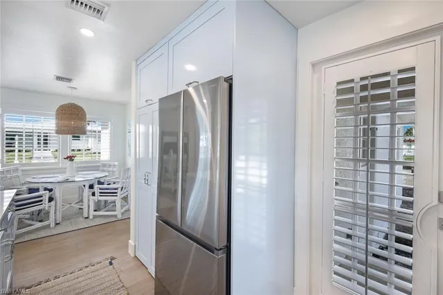 a kitchen with stainless steel appliances a refrigerator and a stove top oven