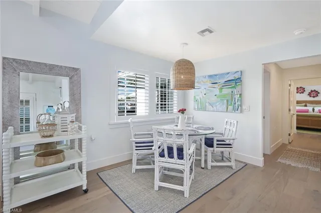 a view of a dining room with furniture and window