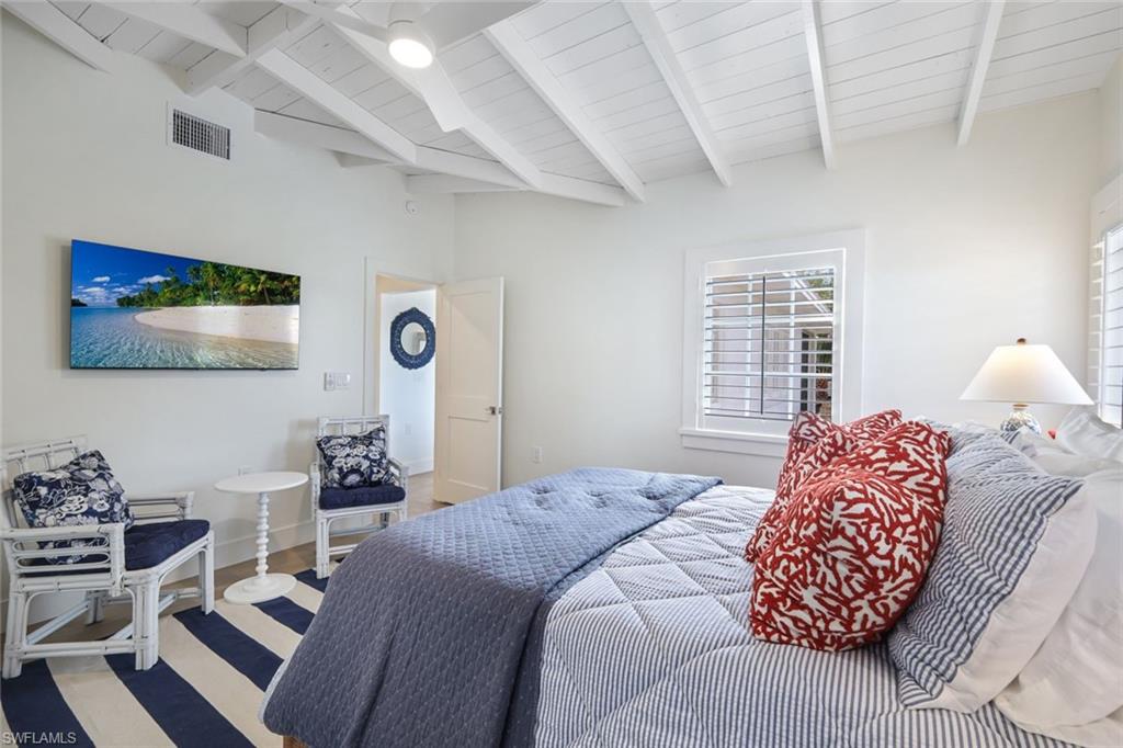 47 8th Avenue South Naples, FL 34102 - Photo 15 of 27 Primary Bedroom with King Bed and Seating Area
