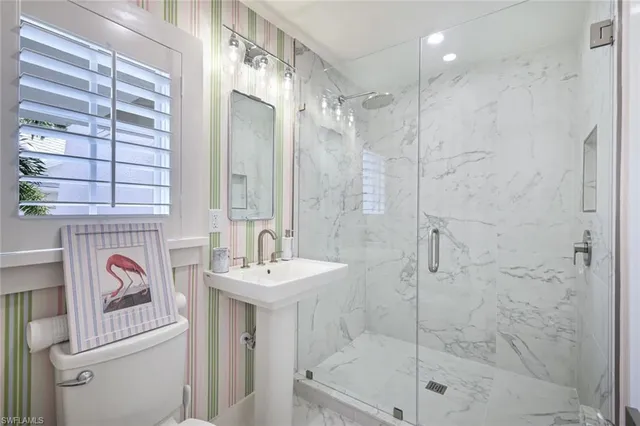 a bathroom with a shower sink and mirror