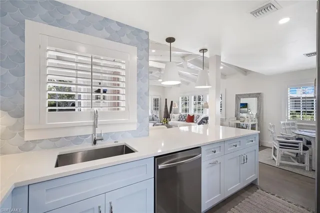 a kitchen with a sink cabinets and window