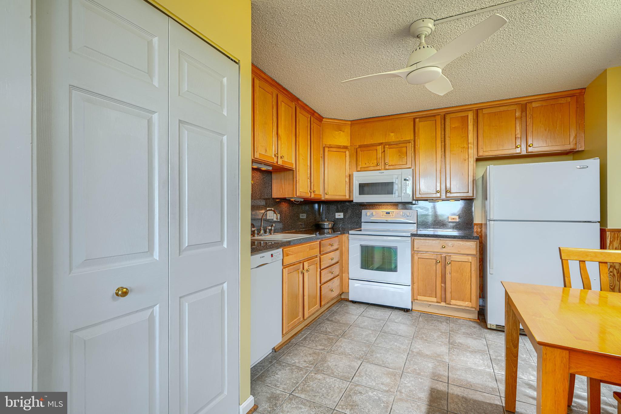 4100 North Charles Street, Unit 1010 Baltimore, MD 21218 - Photo 28 of 73 Kitchen with stacking washer/dryer