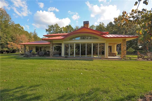3085 Lake Road Woodlawn, TN 37191 - Photo 3 of 20 LUXURIOUS IN FEEL, THE HOME INCLUDES ABUNDANT WINDOWS, TERRACES, AND AN EXPANSIVE SUNROOM, LOCATED BENEATH THE HOME'S ICONIC CURVED ROOF.