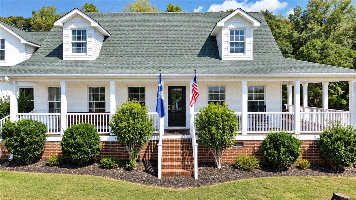 2420 Rainey Road Starr, SC 29684 - Photo 3 of 36 A classic front porch wraps around this brick-foundation home with dormer windows.