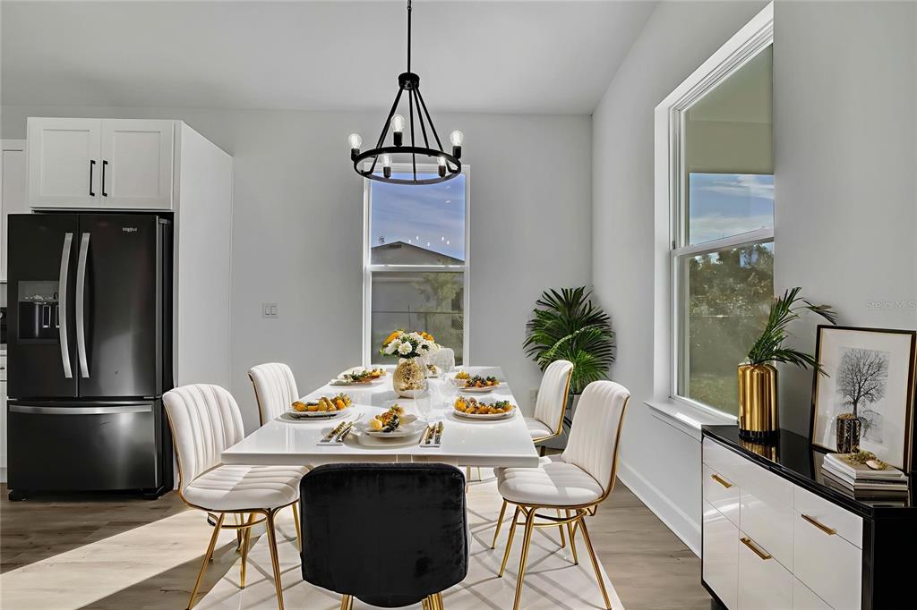 6513 Owl Road Weeki Wachee, FL 34613 - Photo 15 of 47 a view of a dining room with furniture window and wooden floor