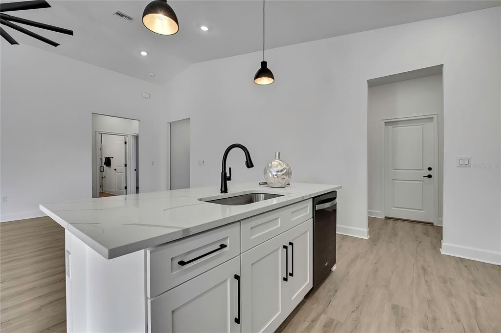 6513 Owl Road Weeki Wachee, FL 34613 - Photo 22 of 47 a kitchen with sink a faucet and appliances