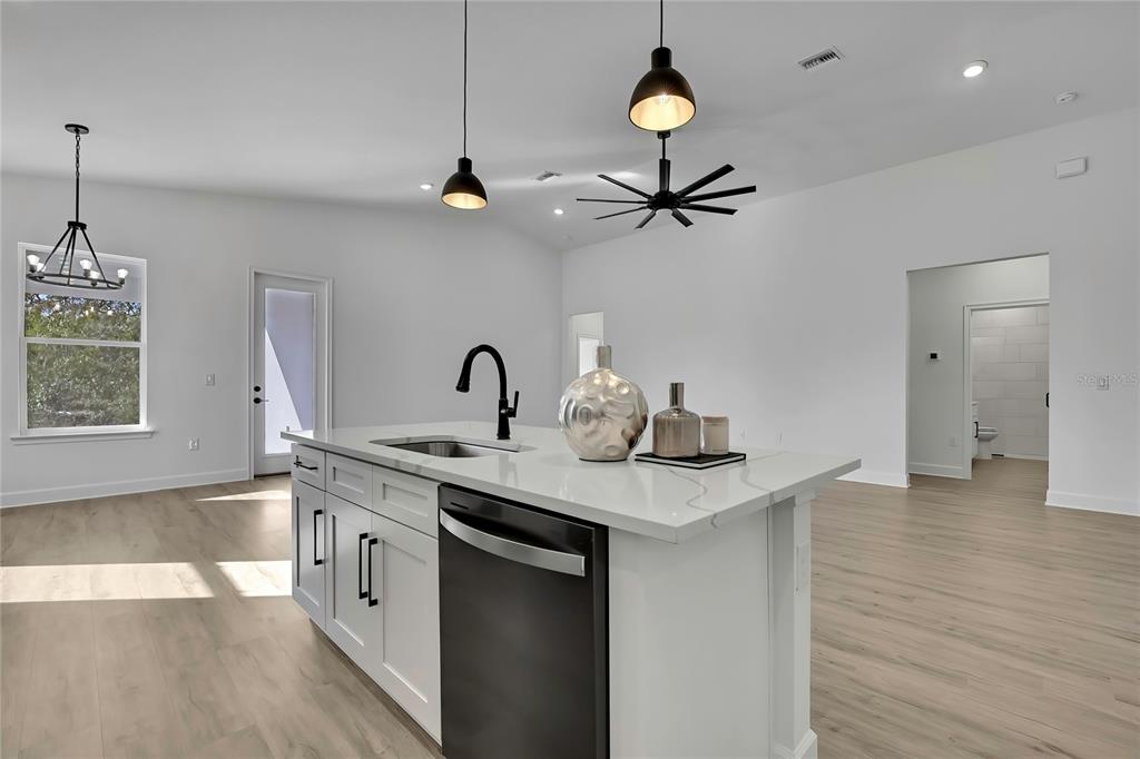 6513 Owl Road Weeki Wachee, FL 34613 - Photo 23 of 47 a kitchen with stainless steel appliances granite countertop a sink a stove and a wooden floors