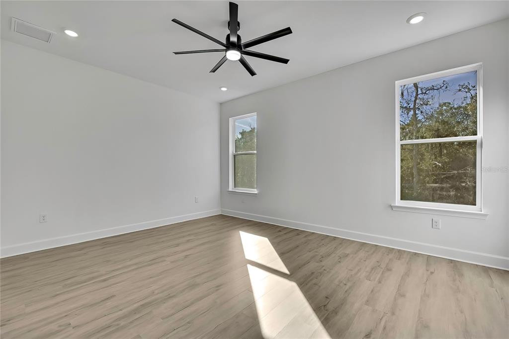 6513 Owl Road Weeki Wachee, FL 34613 - Photo 24 of 47 wooden floor in an empty room with a window