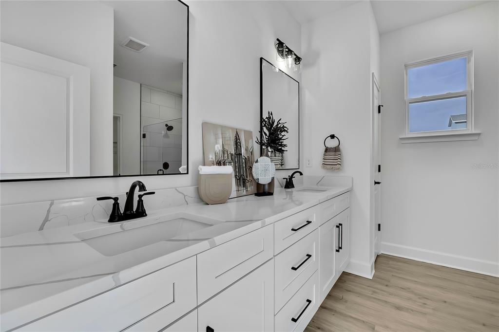 6513 Owl Road Weeki Wachee, FL 34613 - Photo 28 of 47 a bathroom with a double vanity sink and a mirror