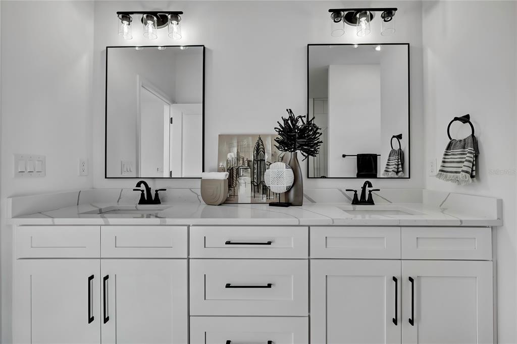 6513 Owl Road Weeki Wachee, FL 34613 - Photo 29 of 47 a bathroom with double vanity sinks and a mirror