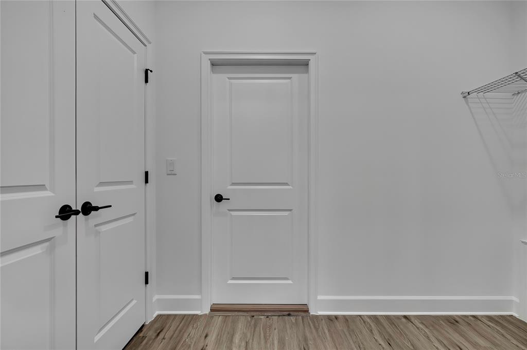 6513 Owl Road Weeki Wachee, FL 34613 - Photo 3 of 47 a view of a hallway with wooden floor