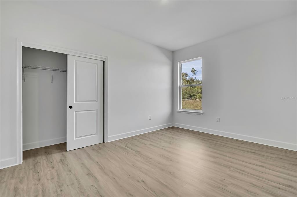 6513 Owl Road Weeki Wachee, FL 34613 - Photo 34 of 47 a view of an empty room with wooden floor and a window
