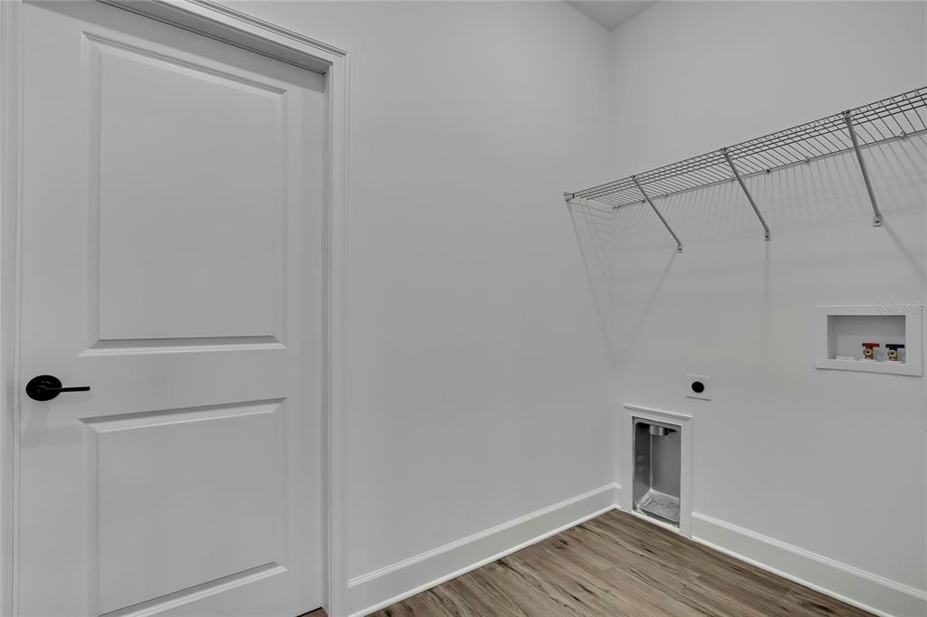 6513 Owl Road Weeki Wachee, FL 34613 - Photo 4 of 47 a view of a room with wooden floor