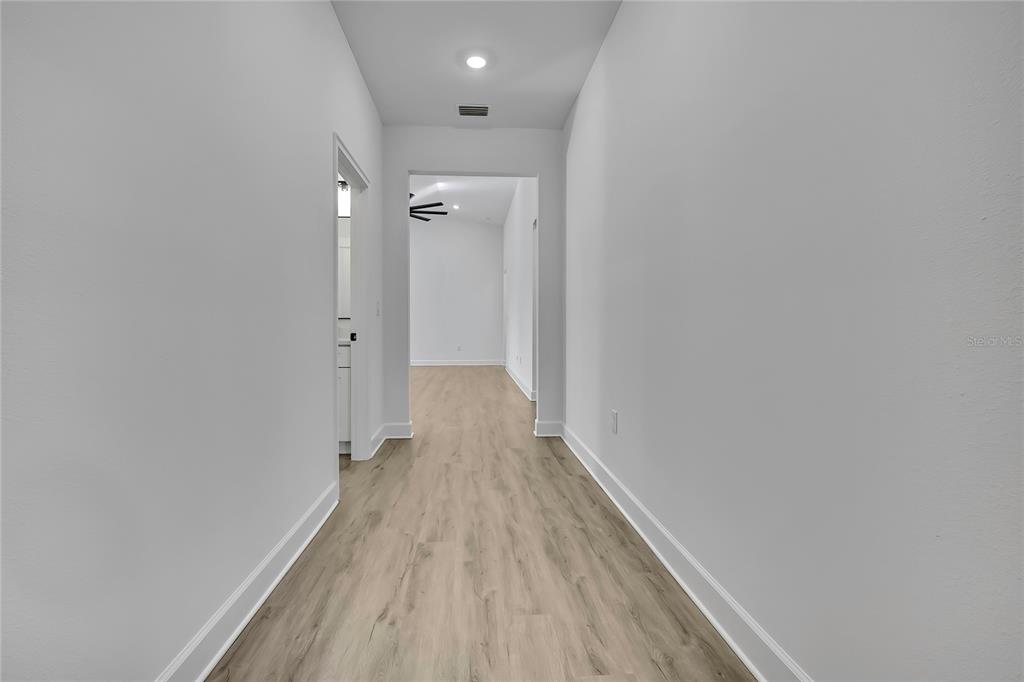 6513 Owl Road Weeki Wachee, FL 34613 - Photo 6 of 47 a view of hallway with wooden floor