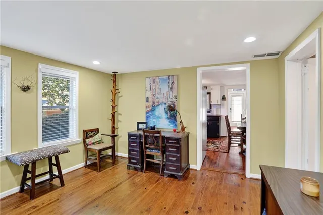 a living room with furniture and a wooden floor