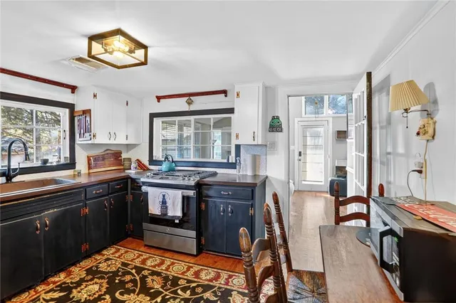 a kitchen with stainless steel appliances granite countertop a stove and more cabinets