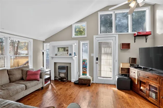 a living room with furniture fireplace and flat screen tv