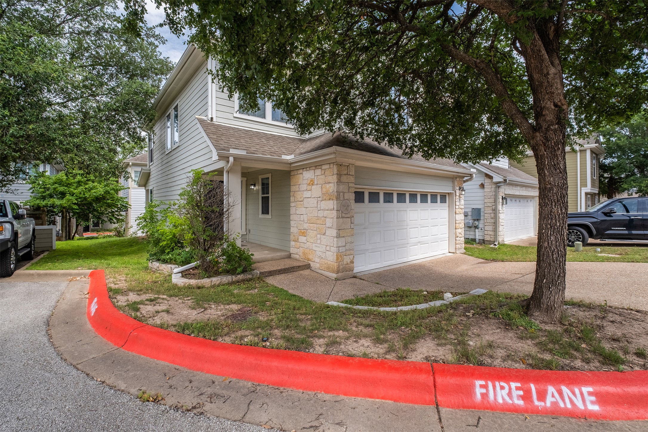 6715 Windrift Way, Unit 8 Austin, TX 78745 - Photo 2 of 24 A welcoming facade showcases stone accents and an attached garage.