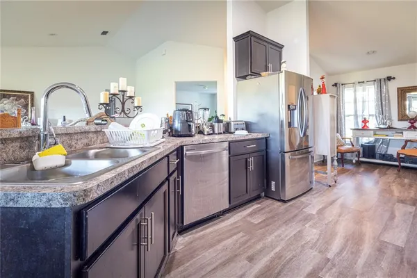 a kitchen with refrigerator and cabinets