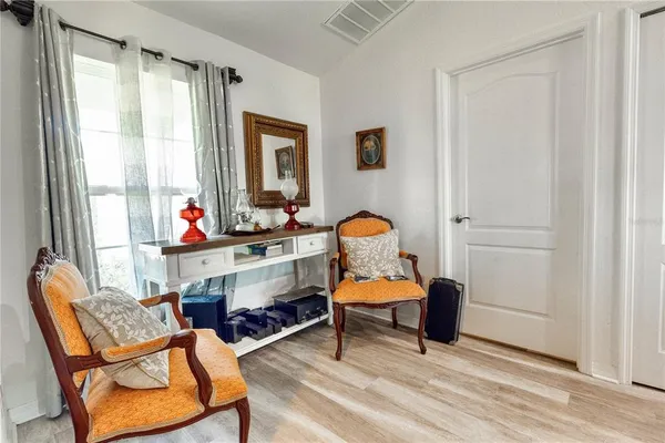 a living room filled with furniture and a window