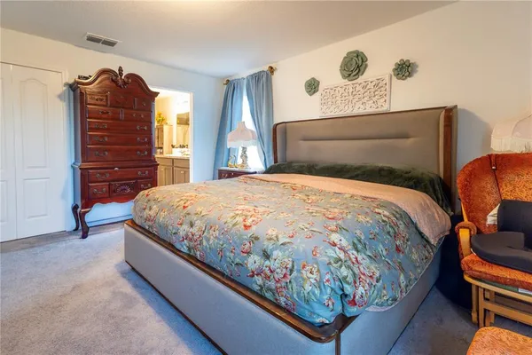 a bedroom with a bed and dresser