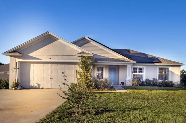 a front view of house with yard and green space