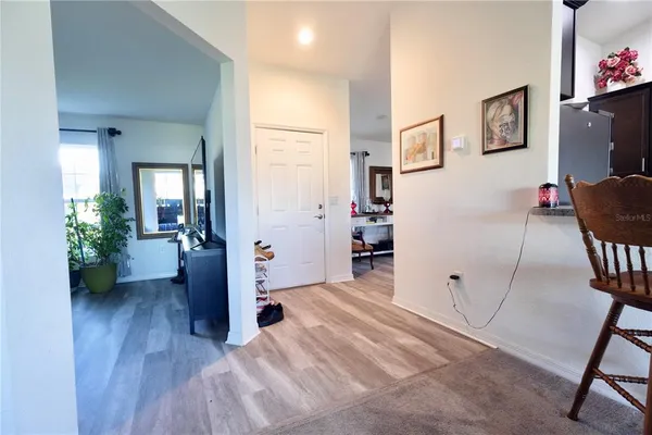 a view of a livingroom with wooden floor and furniture