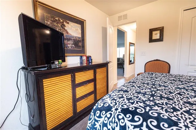 a bedroom with a bed and a dresser