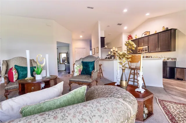 a living room with furniture a flat screen tv and a table
