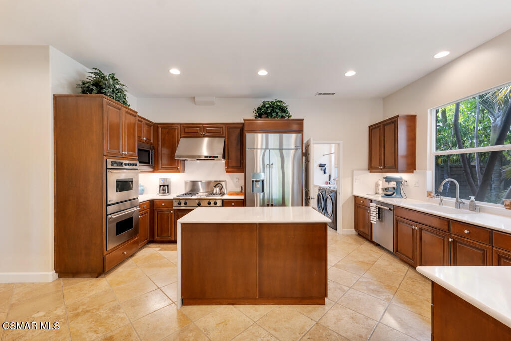 1776 Corte Jubilo Camarillo, CA 93012 - Photo 23 of 74 a large kitchen with kitchen island a large counter top stainless steel appliances and cabinets