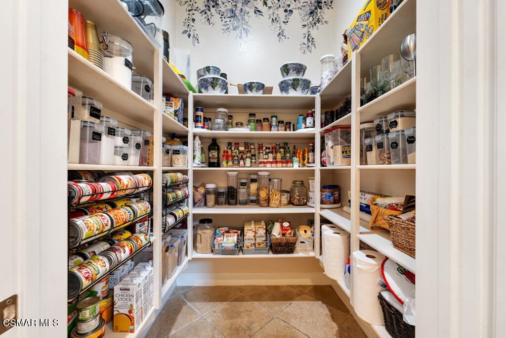 1776 Corte Jubilo Camarillo, CA 93012 - Photo 26 of 74 a room with lots of books and a painting on the wall