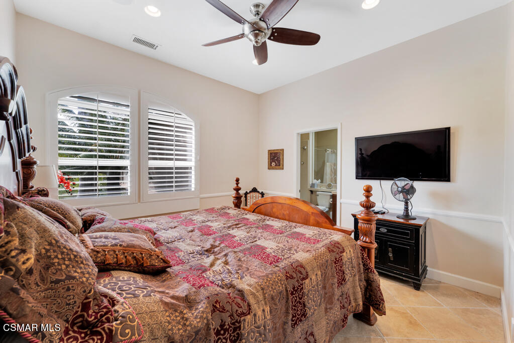 1776 Corte Jubilo Camarillo, CA 93012 - Photo 42 of 74 a bedroom with a bed television and a large window