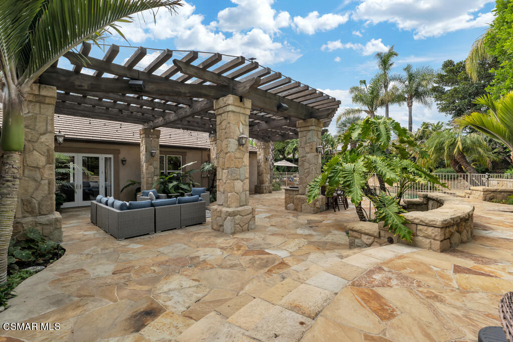1776 Corte Jubilo Camarillo, CA 93012 - Photo 50 of 74 a view of a patio with dining table and chairs with plants