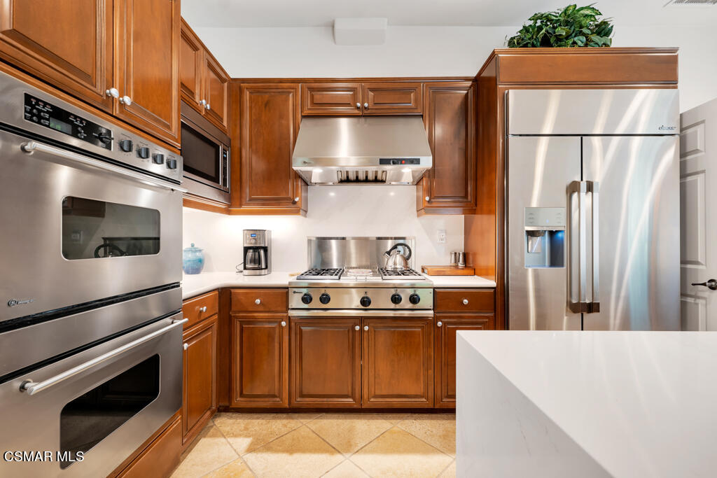 1776 Corte Jubilo Camarillo, CA 93012 - Photo 6 of 74 a kitchen with stainless steel appliances granite countertop a stove a refrigerator and a microwave