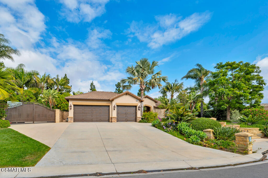 1776 Corte Jubilo Camarillo, CA 93012 - Photo 61 of 74 a front view of a house with a yard and a garage