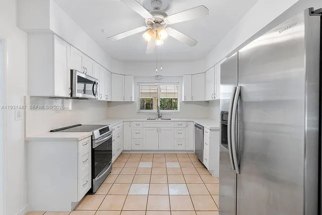 a kitchen with a stove a refrigerator and a sink