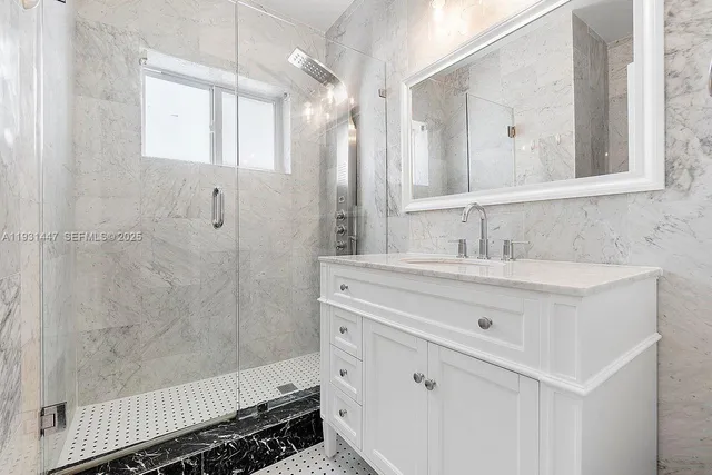 a bathroom with a double vanity sink mirror and shower