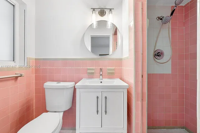 a bathroom with a toilet sink and mirror