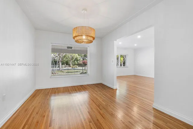 a view of room with window and wooden floor