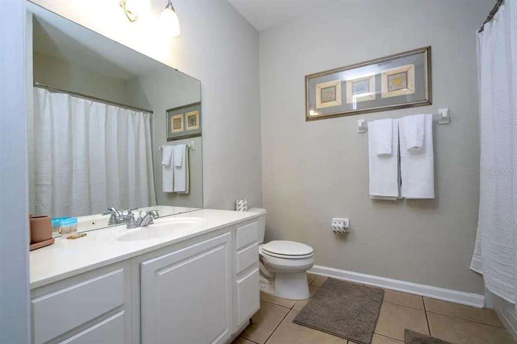 5025 Shoreway Loop, Unit 10703 Orlando, FL 32819 - Photo 17 of 53 a bathroom with a sink toilet and vanity