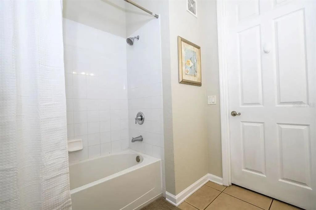 5025 Shoreway Loop, Unit 10703 Orlando, FL 32819 - Photo 18 of 53 a bathroom with a bathtub